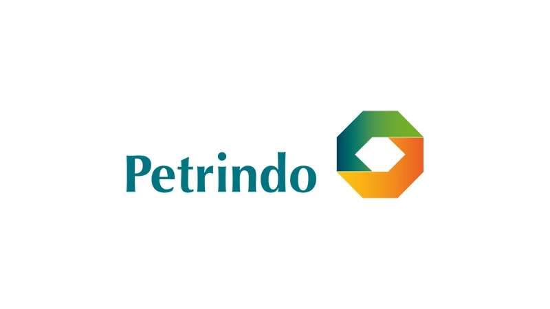 PT Petrindo Jaya Kreasi Tbk logo and office building